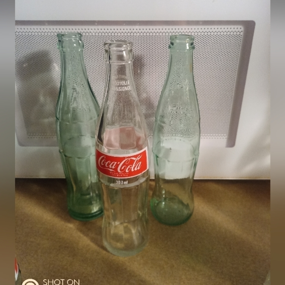 Three Coca Cola Bottles